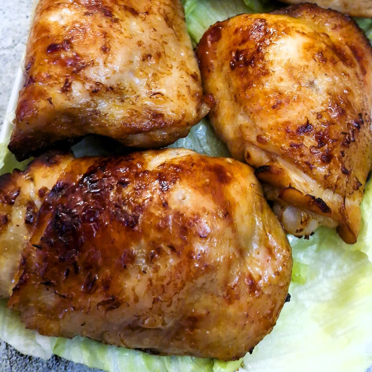 Close up of air fried barbeque chicken thighs.