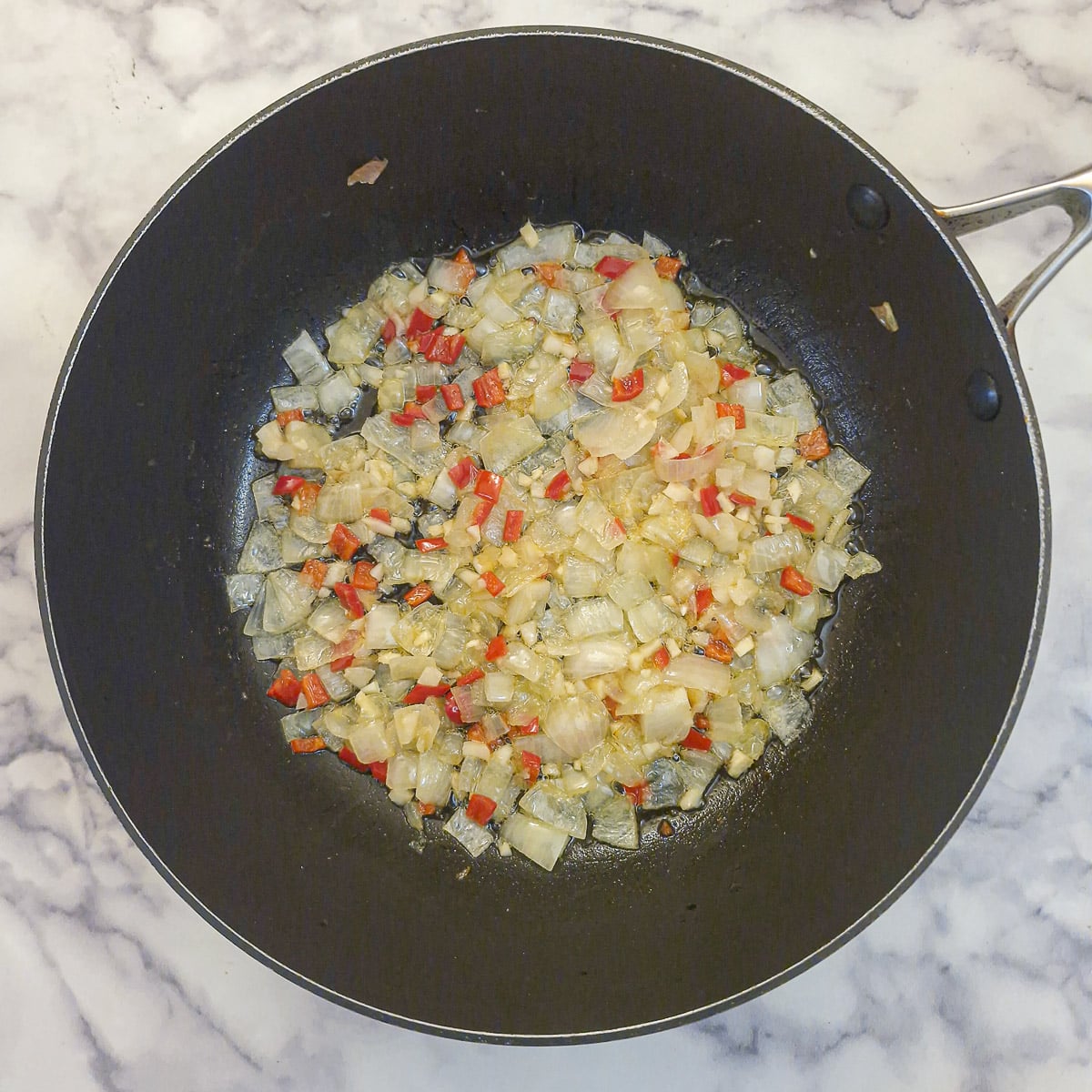 Step 4, chopped chilli and garlic in a pan wth the onions.