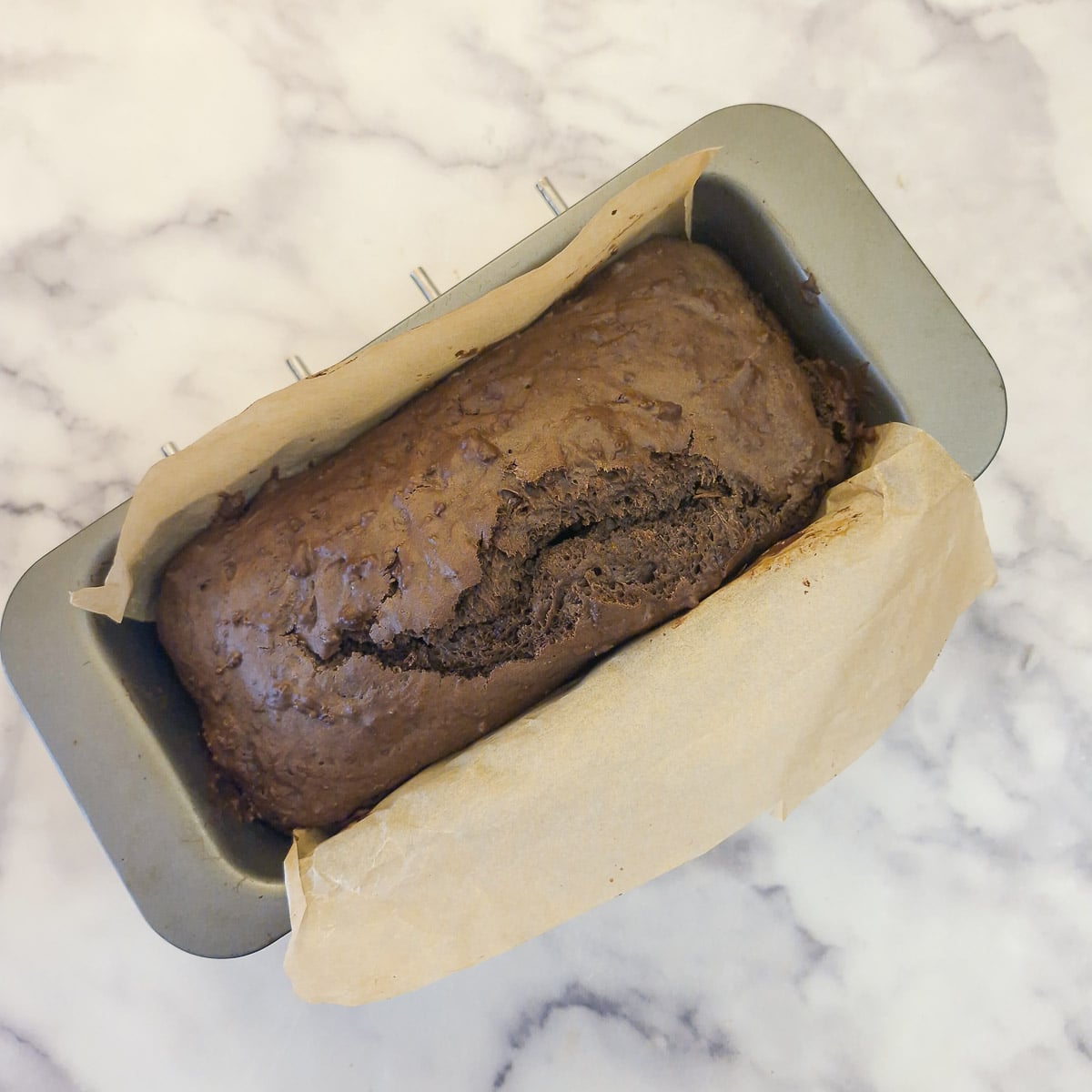 A baked chocolate cake in a loaf tin.