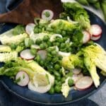 Pea and broad bean salad in a bue serving dish.