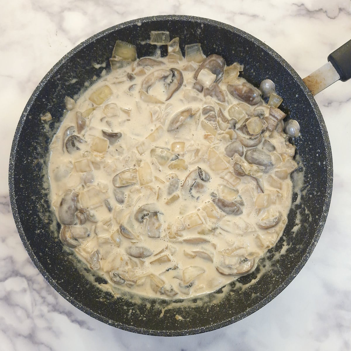 Cream stirred into mushrooms and onions.