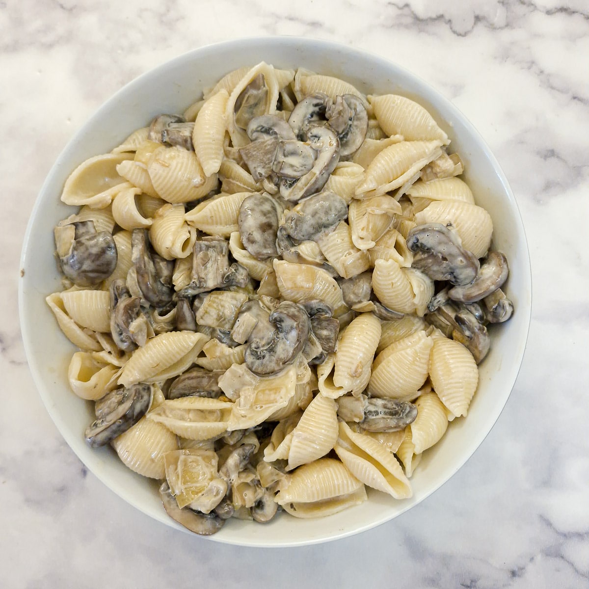A serving dish of creamy mushroom chutney pasta salad.