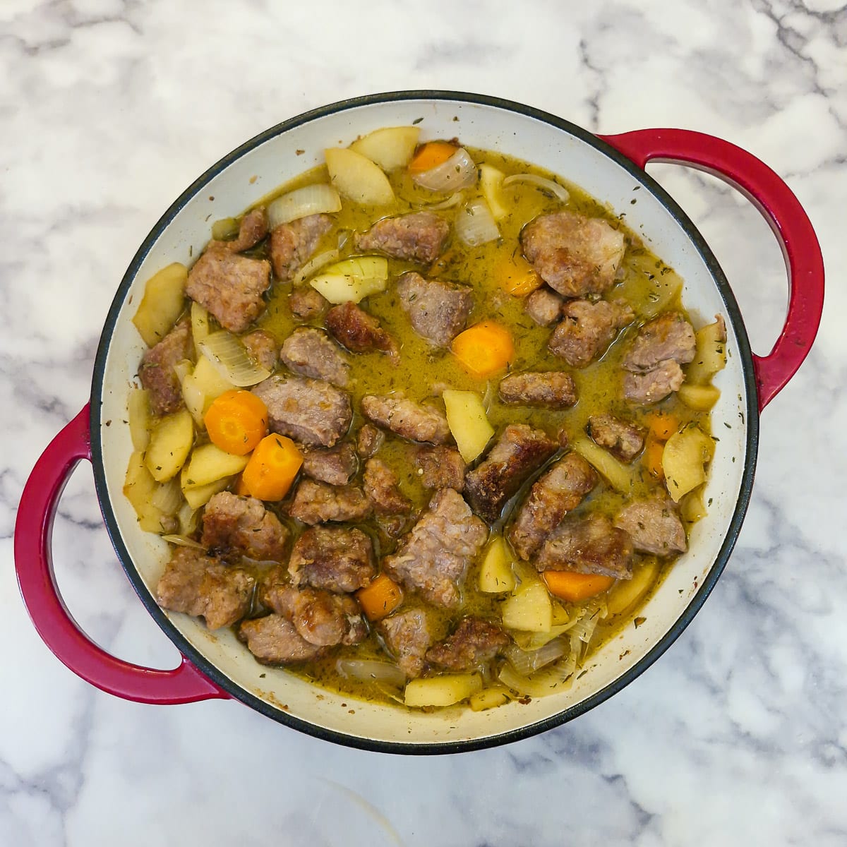 Stock and pork pieces added to the pork casserole.