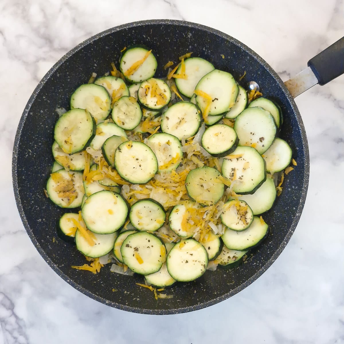 Sliced zucchini and grated carrots added to the onions.