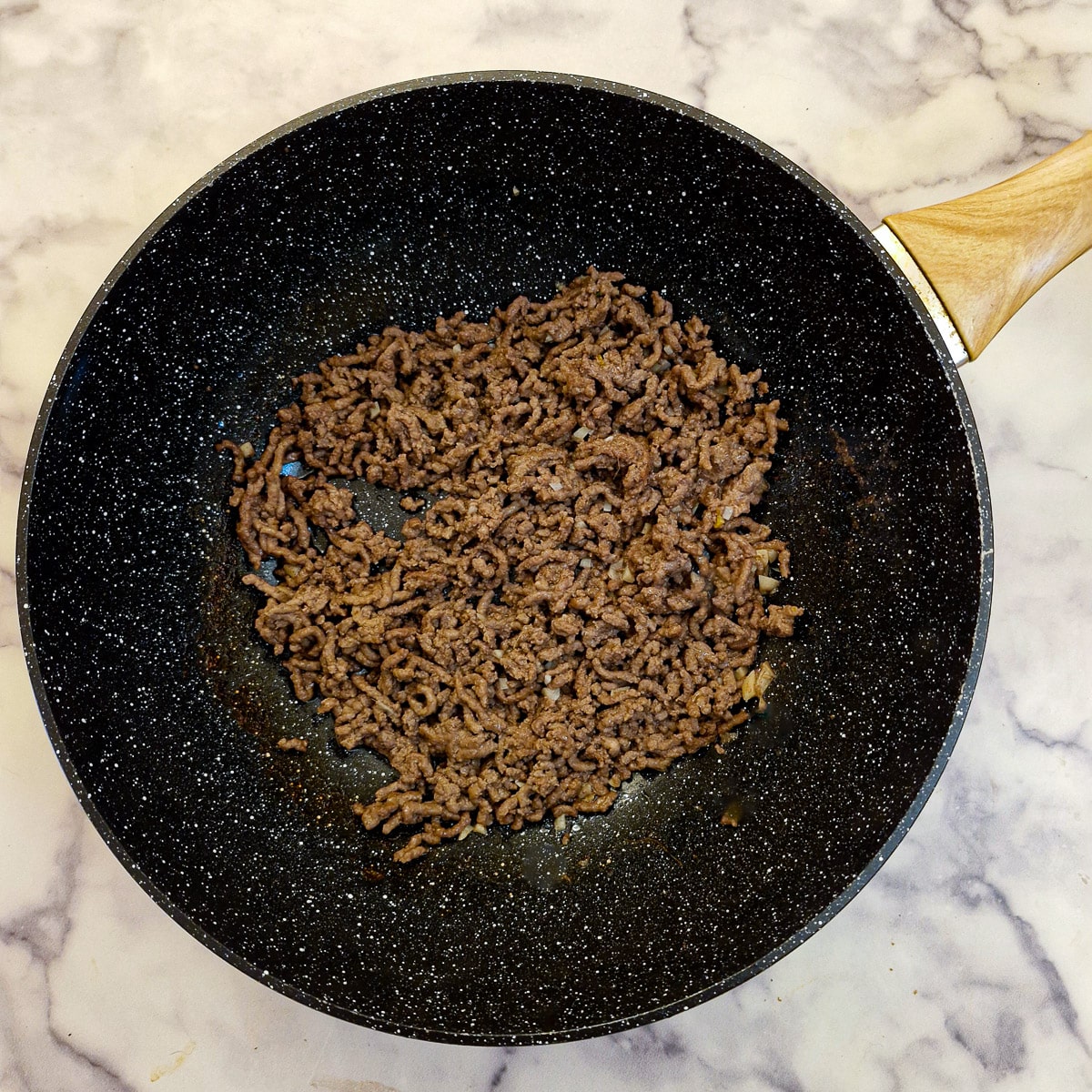 Step 1, minced beef browning in a wok.