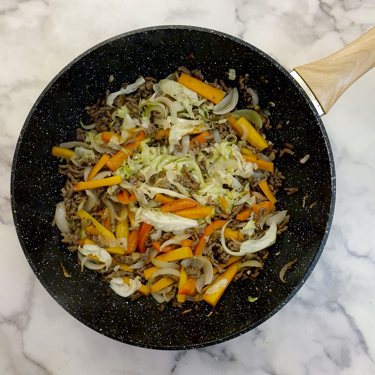 Step 3, shredded cabbage and bean sprouts adde to the chow mein.