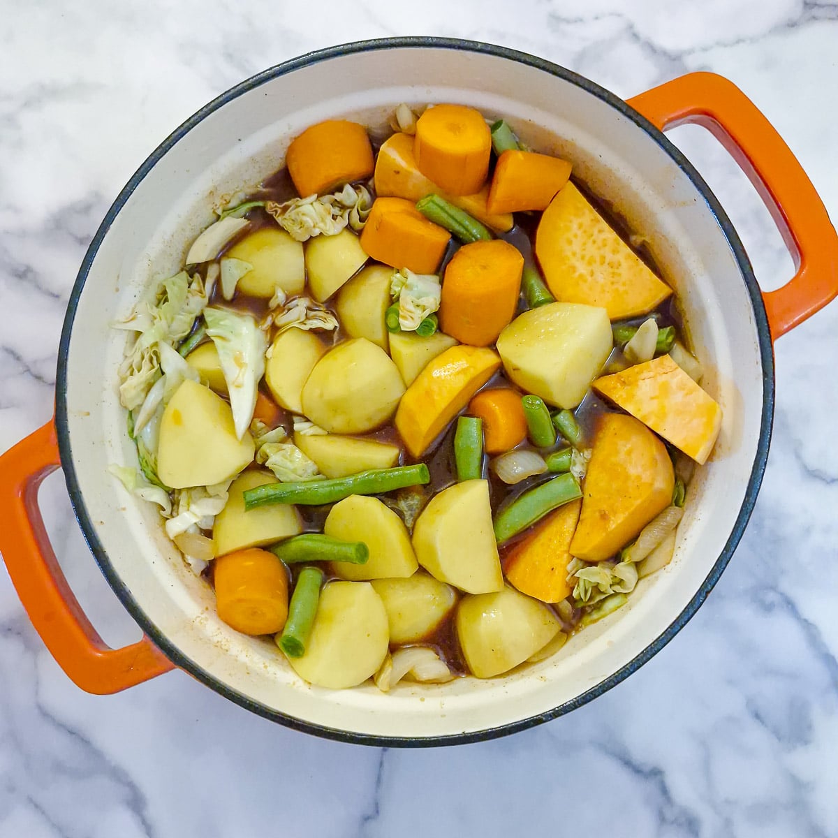 Step 4, vegetables and stock in a cast iron pot.