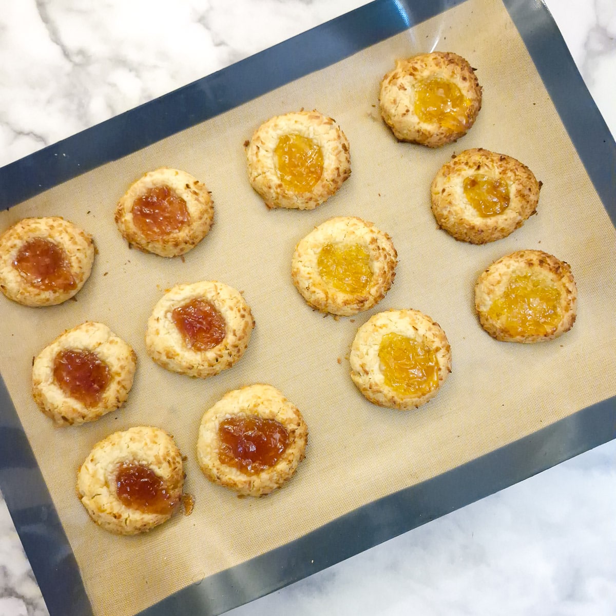 12 baked coconut jam thumbprint cookies.