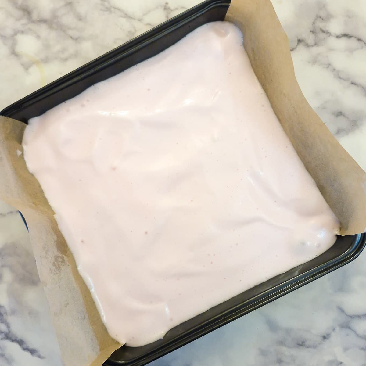 The marshmallow mixture spread evenly on top of the biscuit base.