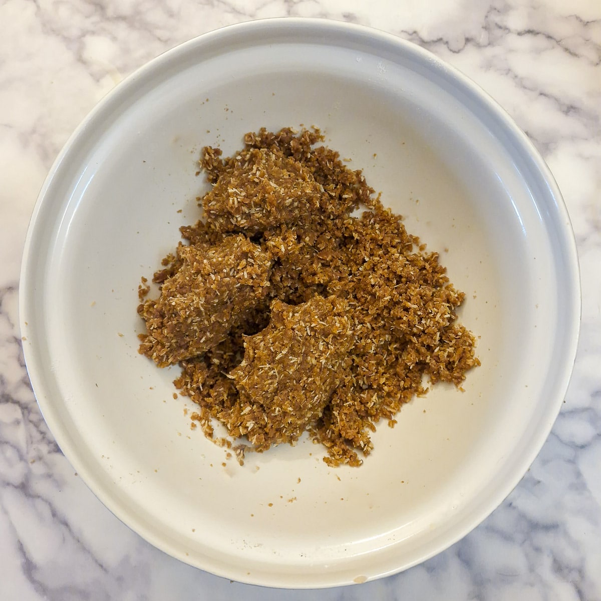 The final mixed biscuit base, showing how the mixture holds together when squeezed.