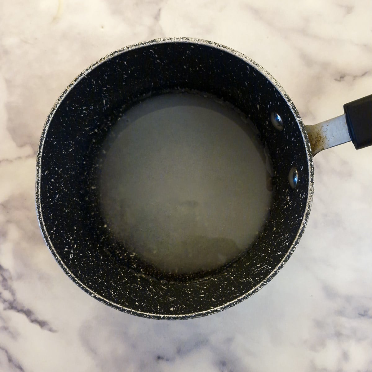 Sugar and water in a saucepan.