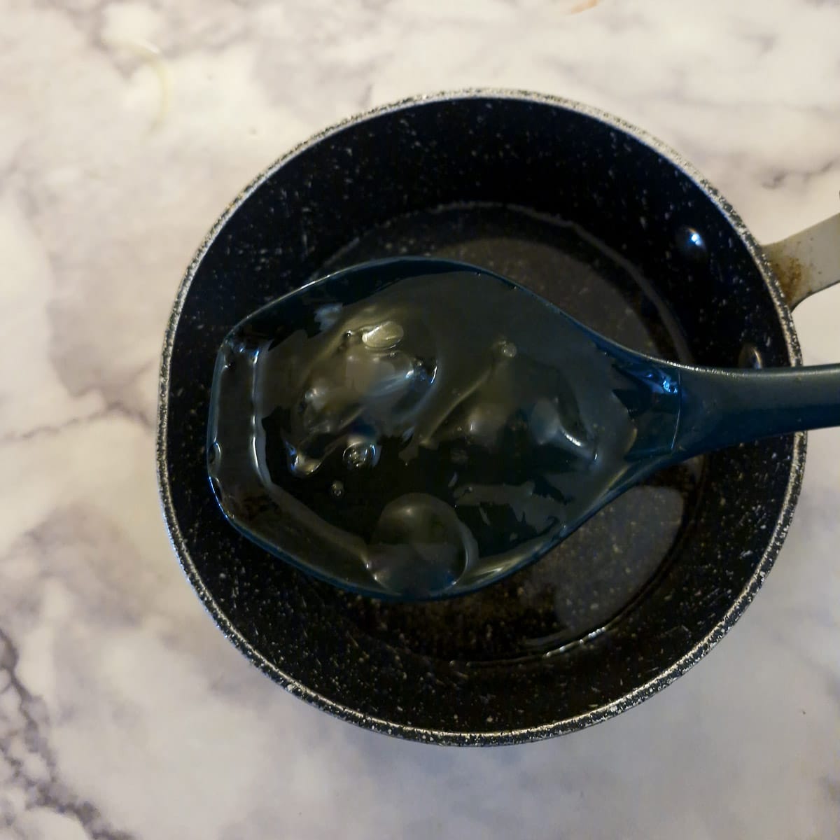 Softened leaf gelatine added to sugar and water in a small saucepan.