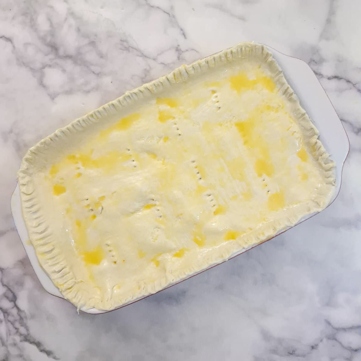 Puff pastry formed into a lid on top of the pie.