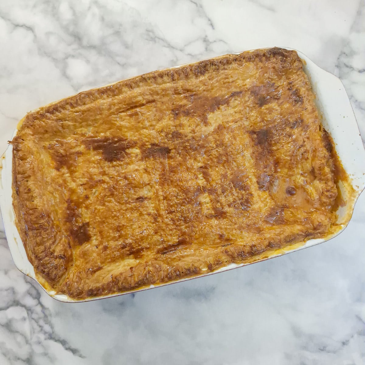 A golden brown baked leftover paprika chicken pie.