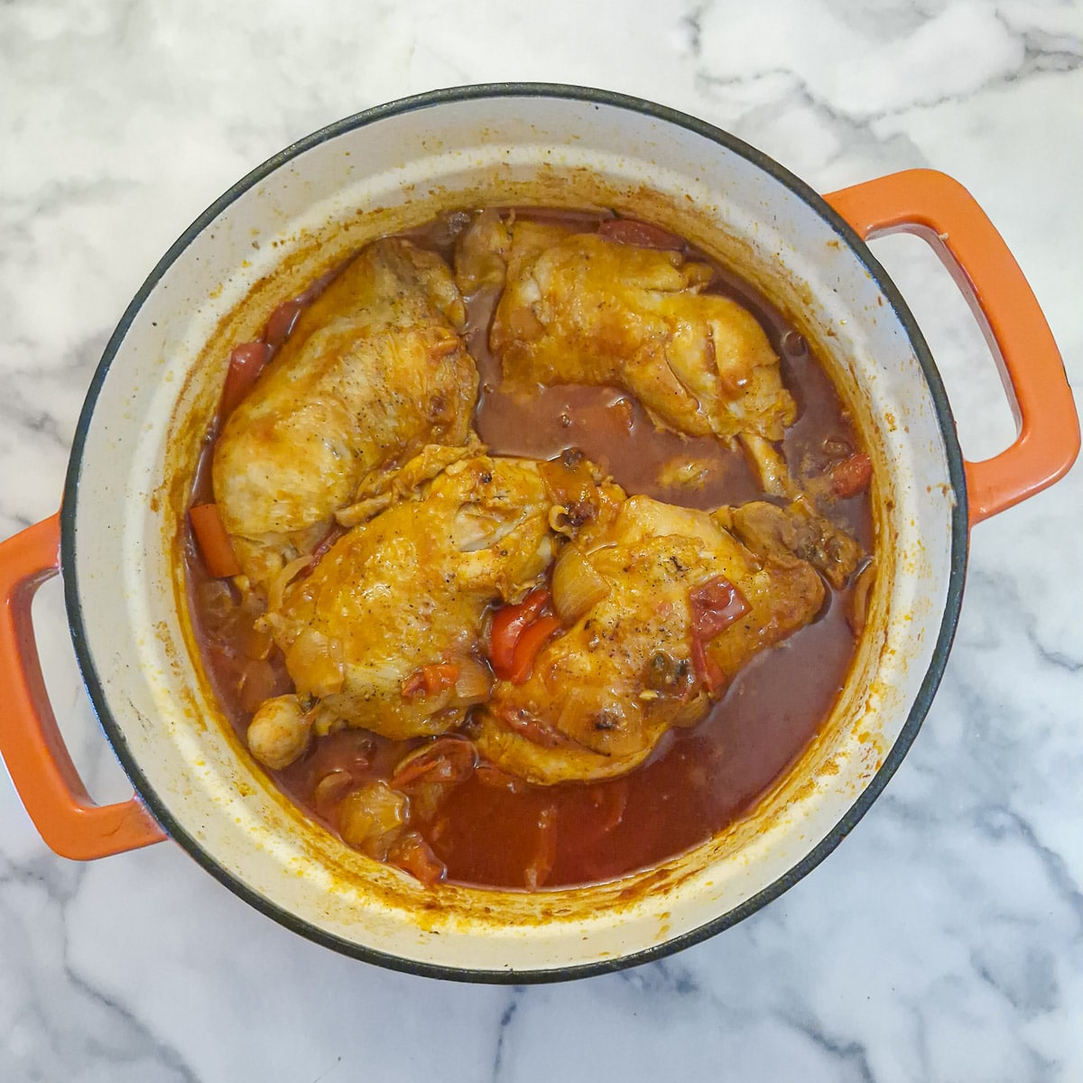Cooked chicken pieces in the paprika sauce.