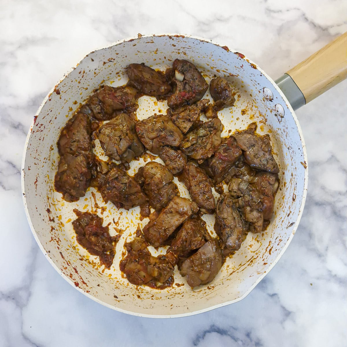 Brandy and tomato puree stirred into the duck livers.