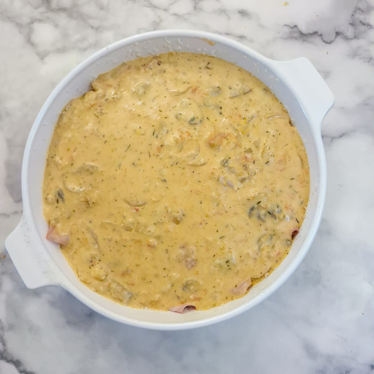 The remaining tomato filling spooned over the mortadella.