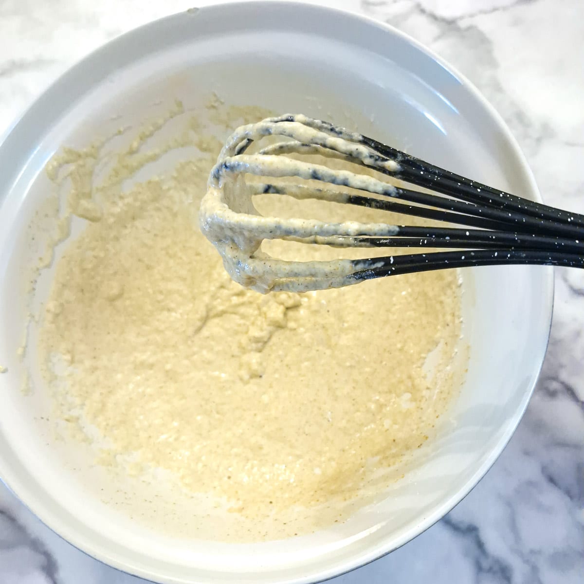 Step 4, beer batter in a mixing bowl with a whisk.