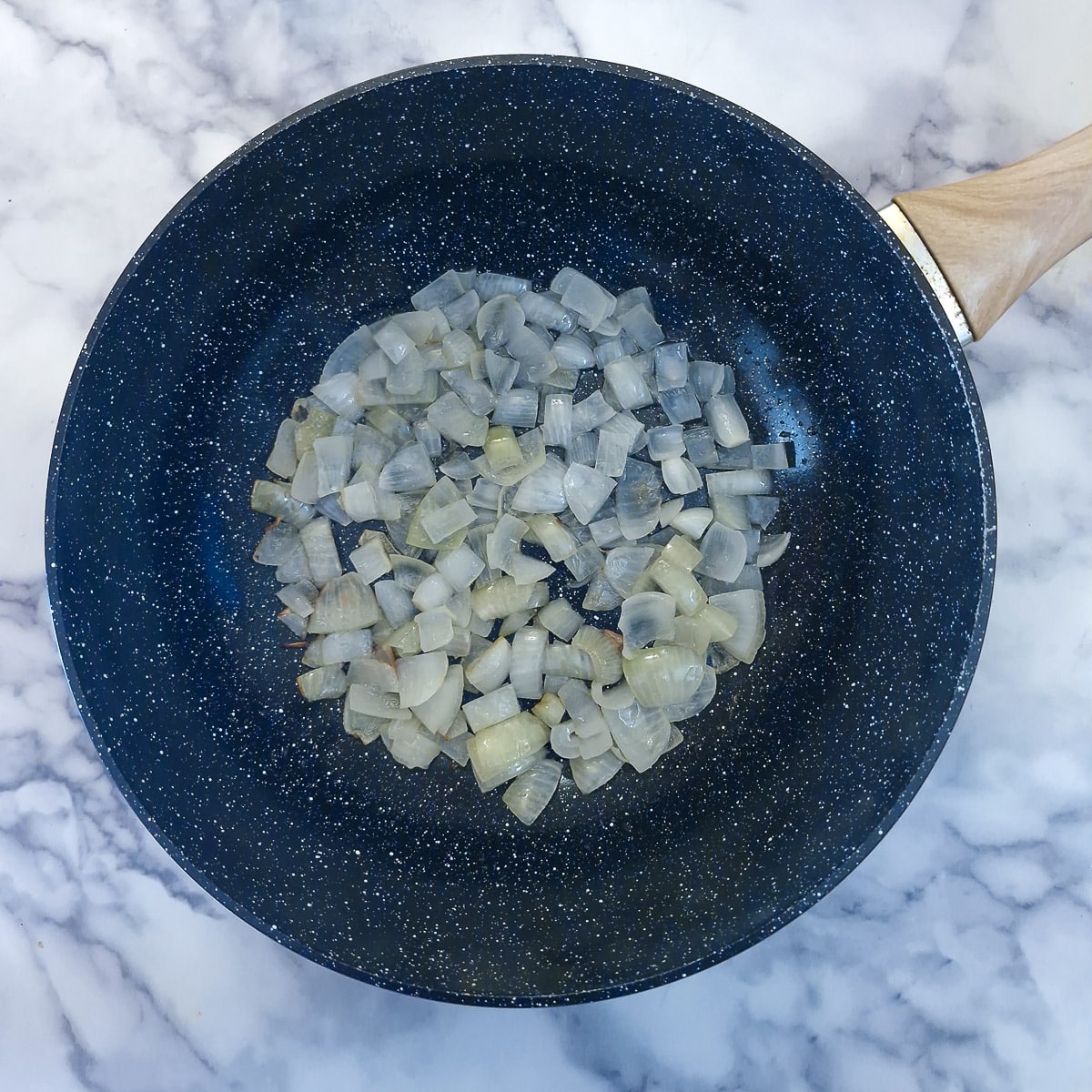 Step 1, diced onions softening in a wok.