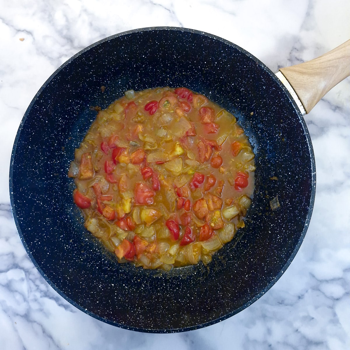 Step 3, diced tomatoes added to the onions.
