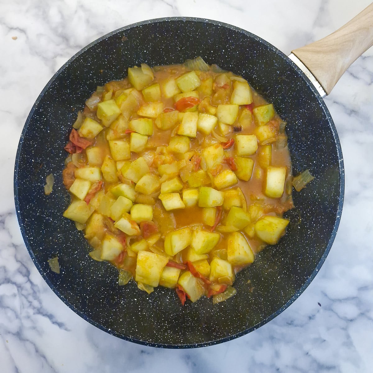 Step 5, half-cooked marrow curry in a wok.