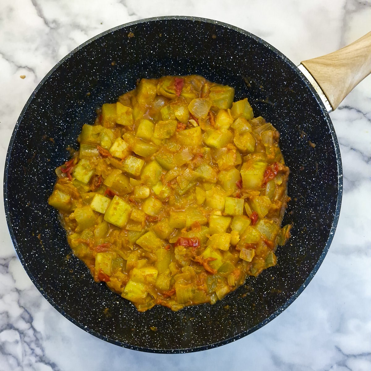Step 6, a wok of fully cooked marrow curry with tomatoes and onions.