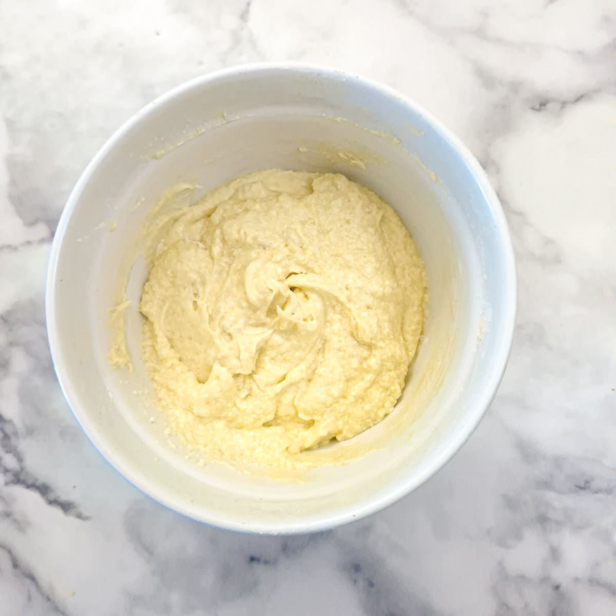 A mixing bowl of fully mixed sponge pudding batter.