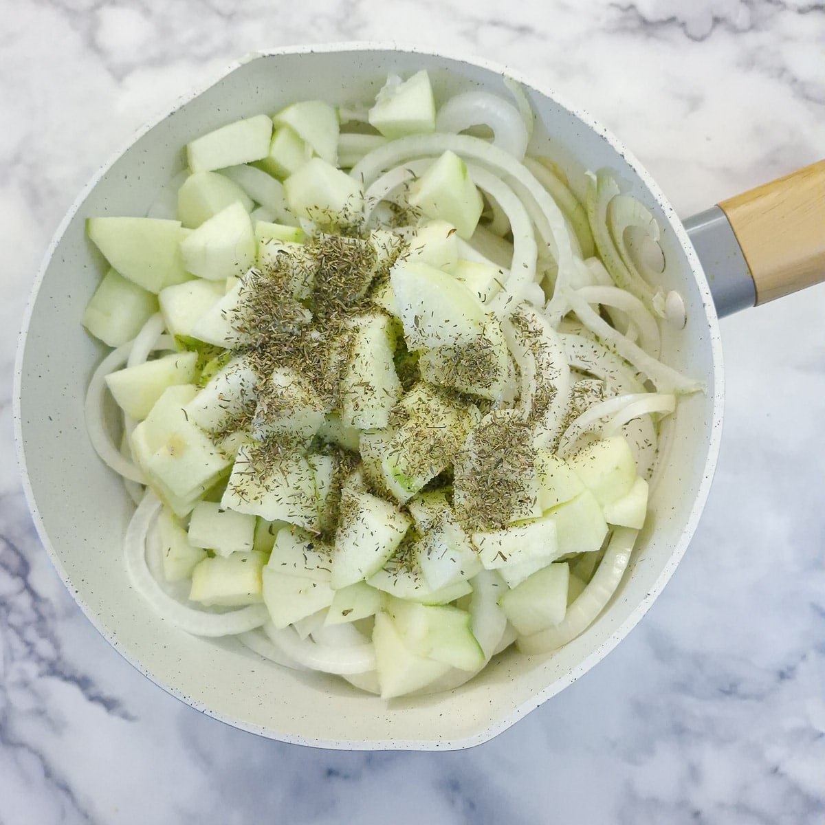 Step 2, apples, thyme and salt added to the onions.