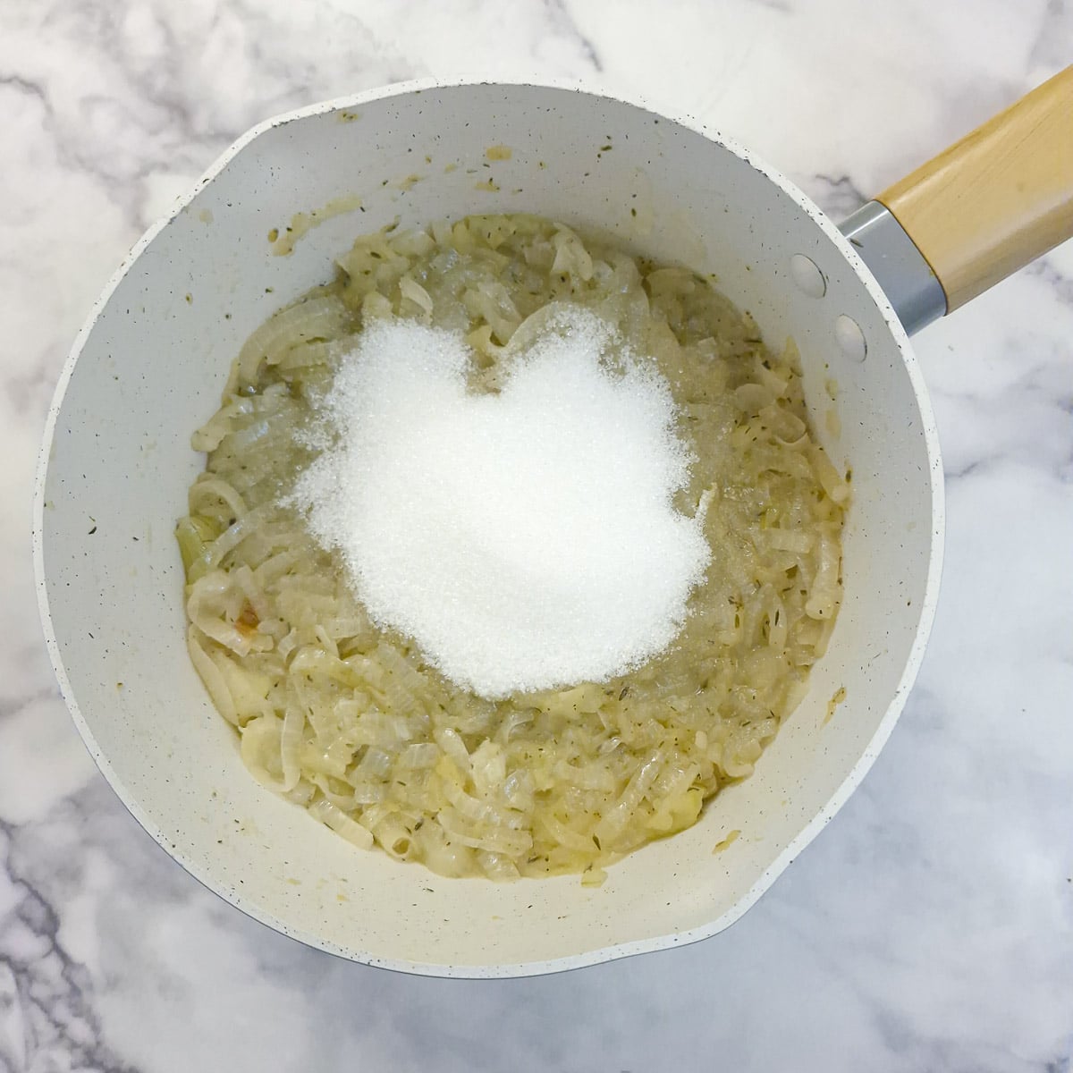 Step 5, sugar and vinegar are added to the softened onions and apples.