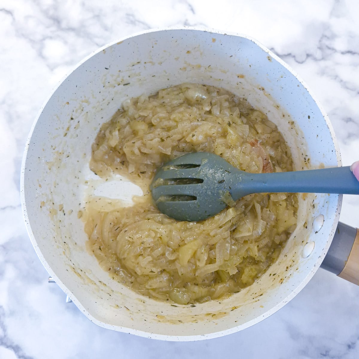 Step 6, the onion marmalade is simmered for another 30 mminutes to thicken. Here you can see a spoon being dragged through the mixture and leaving a distinct trail.