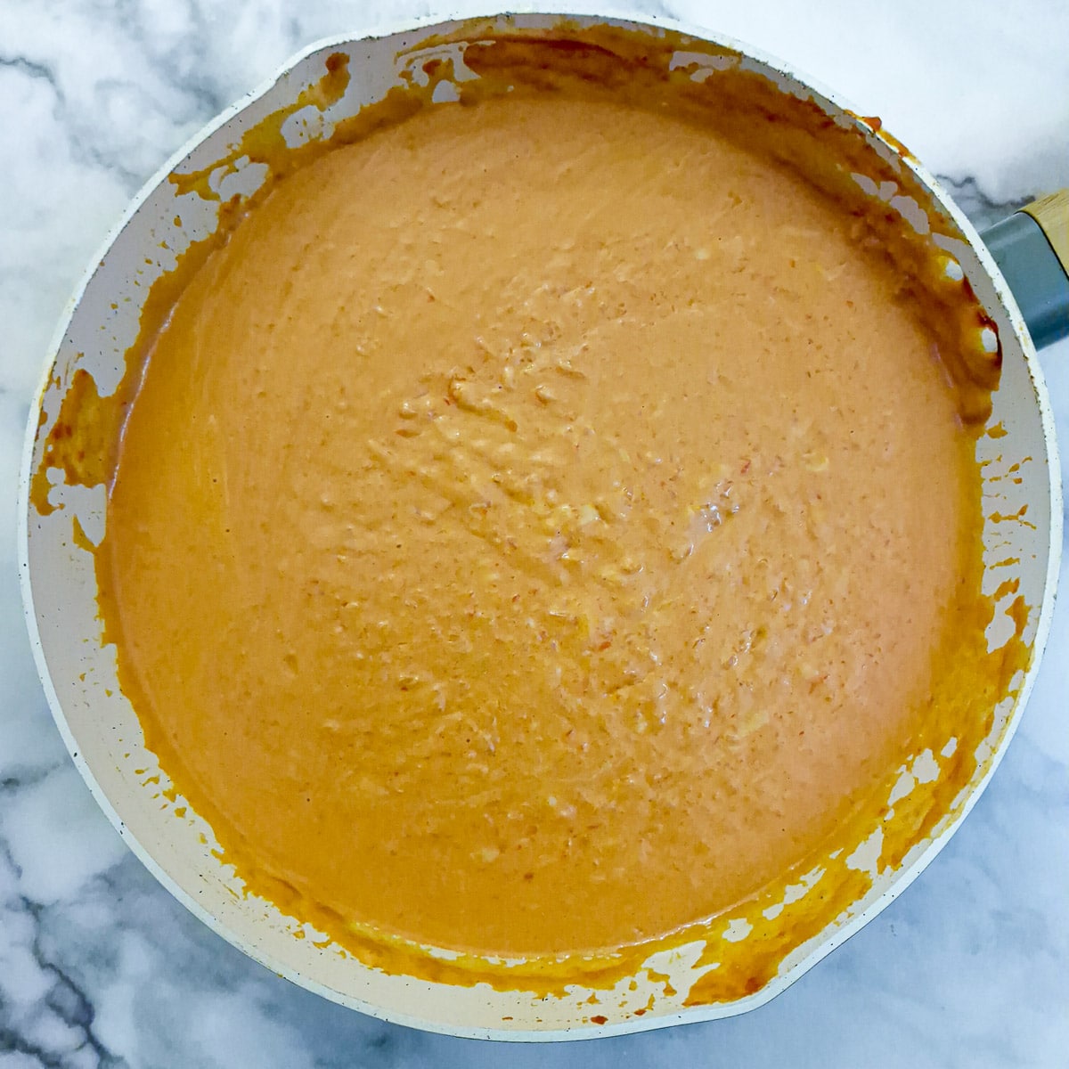 Cream and milk stirred into the red pepper sauce and allowed to thicken.