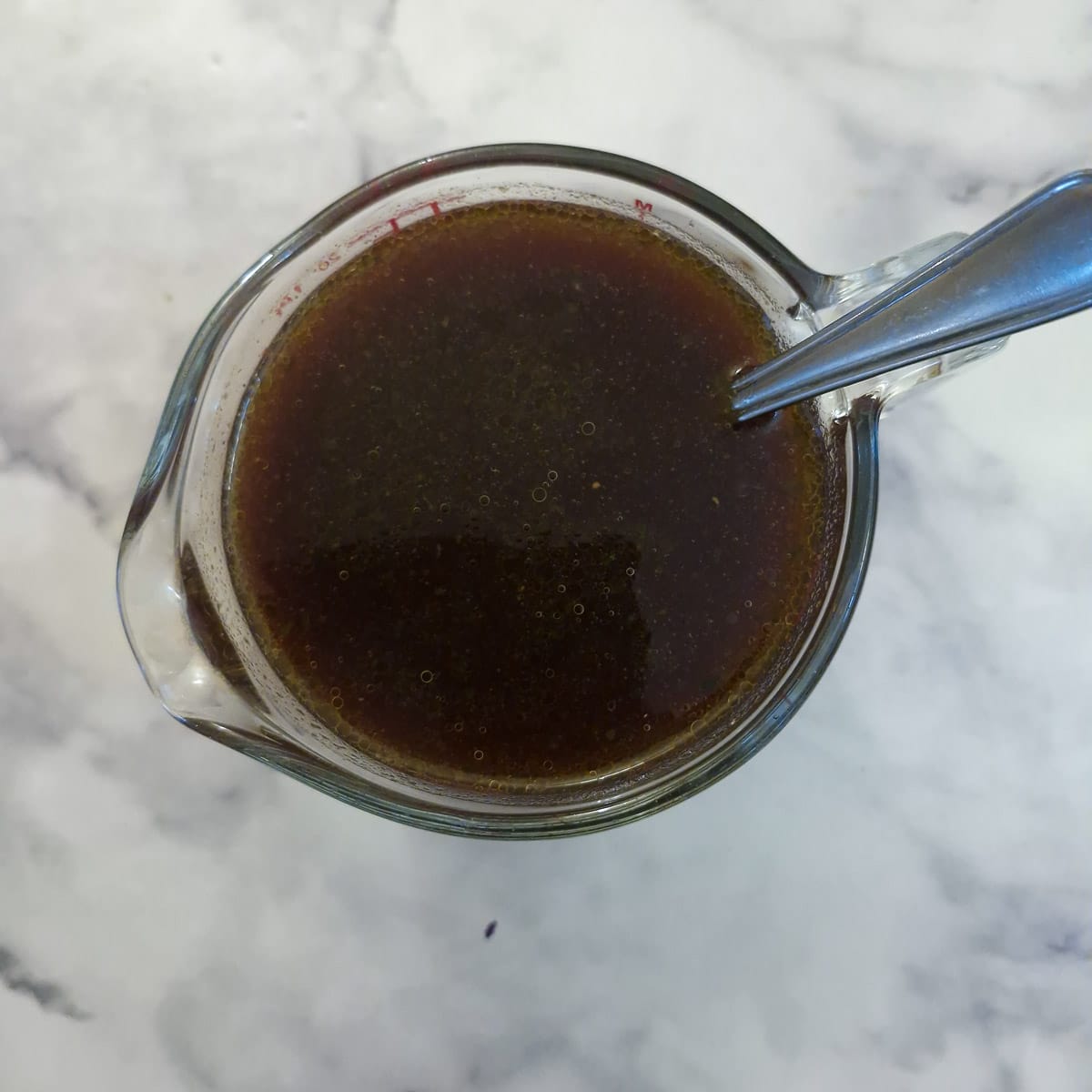 Garlic sauce ingredients combined in a glass jug.