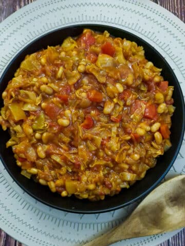 A black serving dish filled with spicy chakalaka.