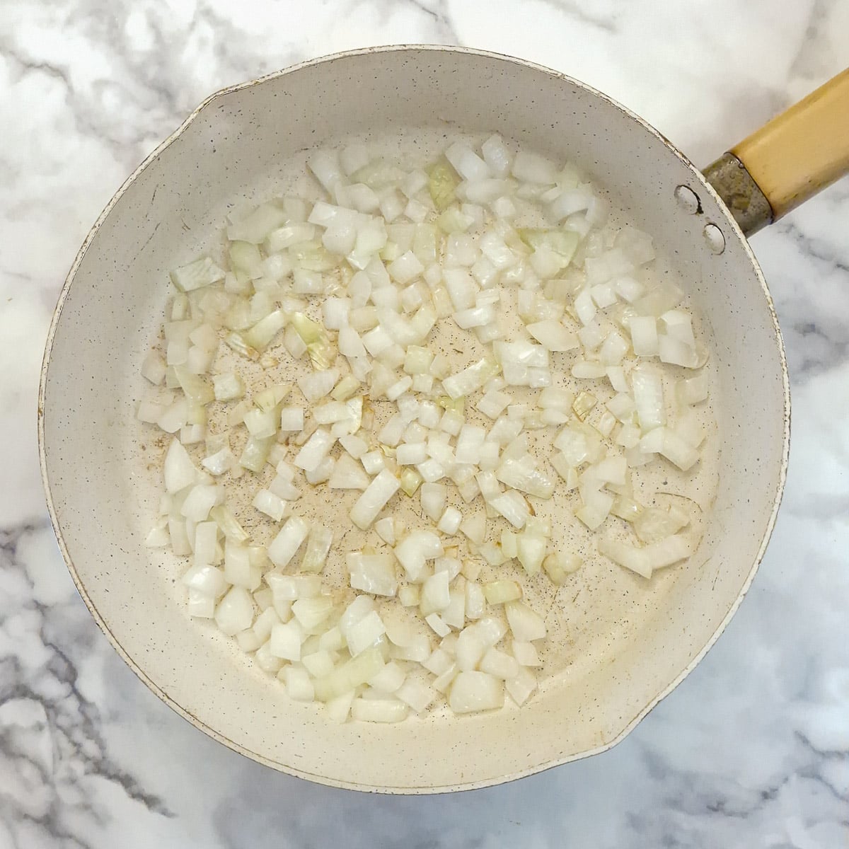 Step 1, onions frying in a pan.