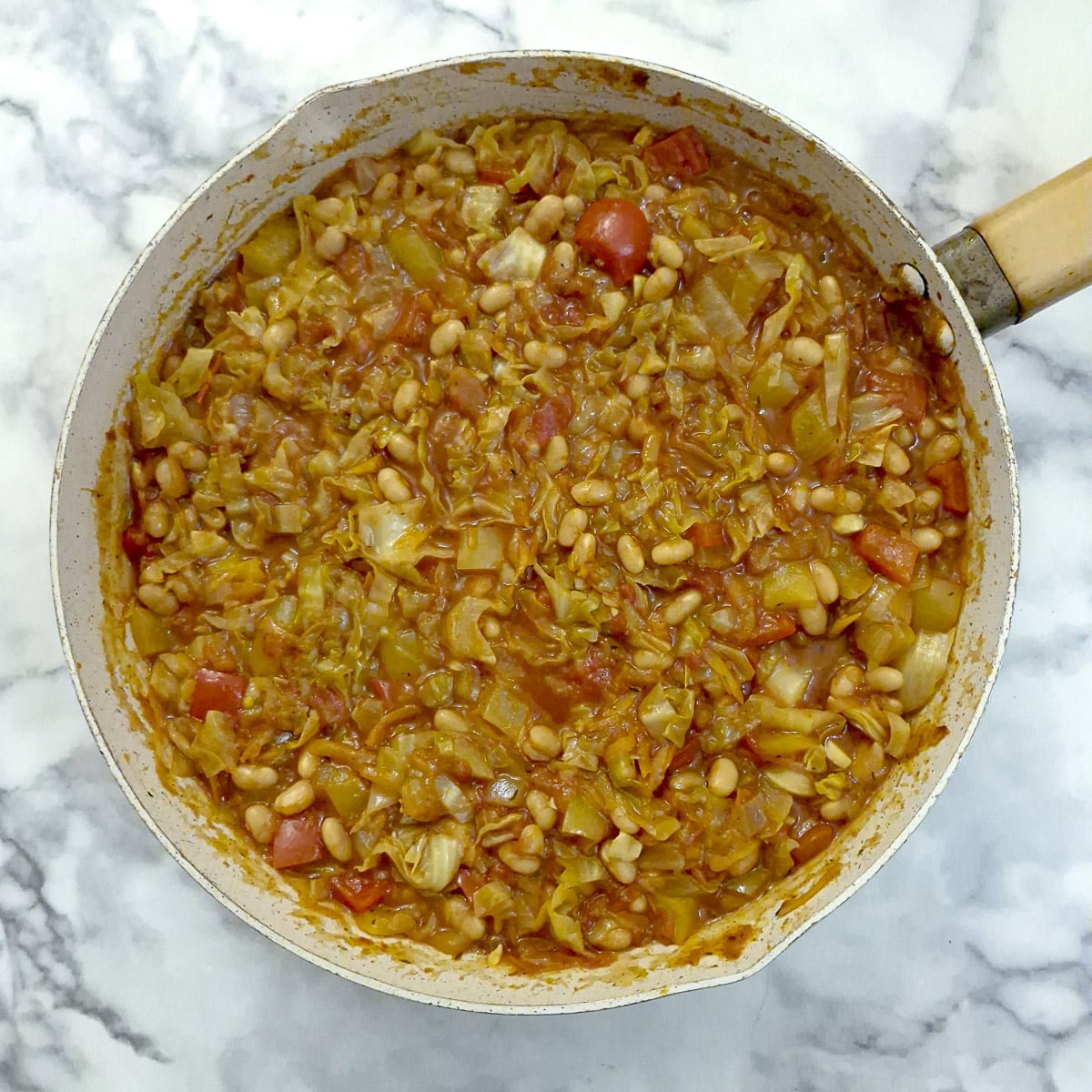 Step 7, baked beans stirred into chakalaka to complete the dish.