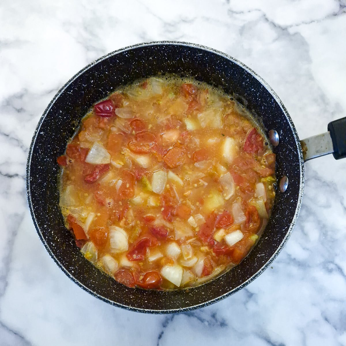 To9matoes and onions that have just come to the boil.