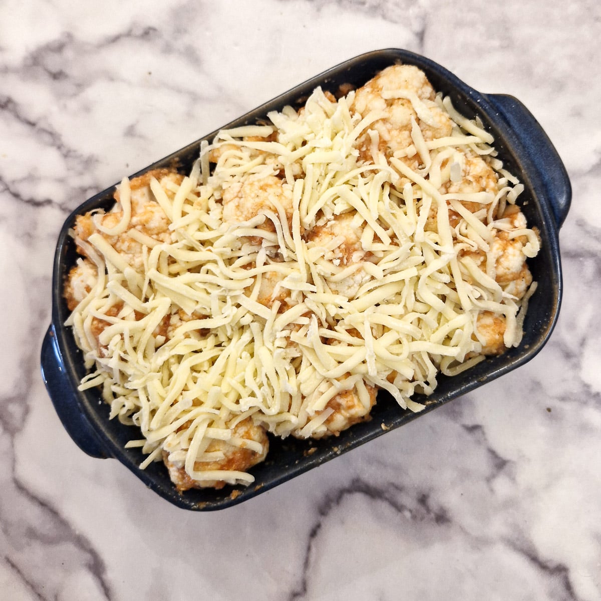 Step 4, grated cheese sprinkled over the cauliflower bake.