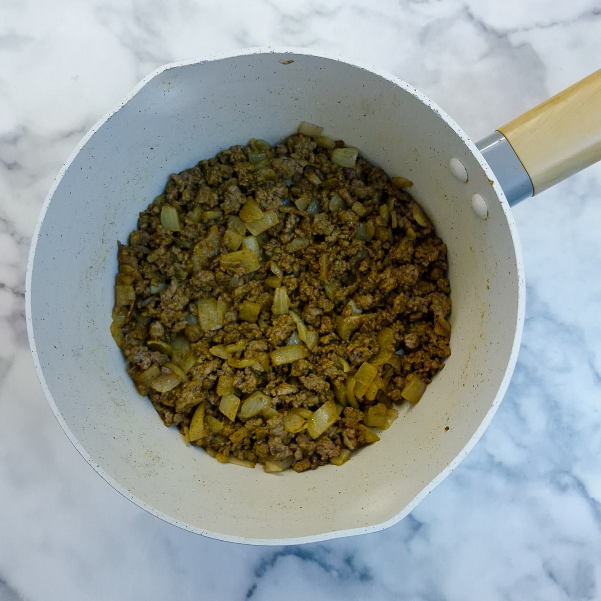 Step 3, curry powder frying with onions and browned beef mince.