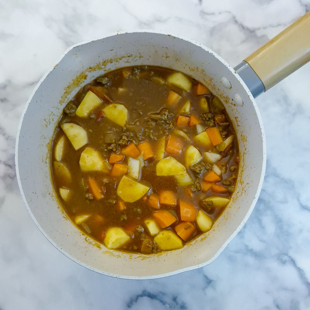 Step 5, stock and vegetables added to the curry.