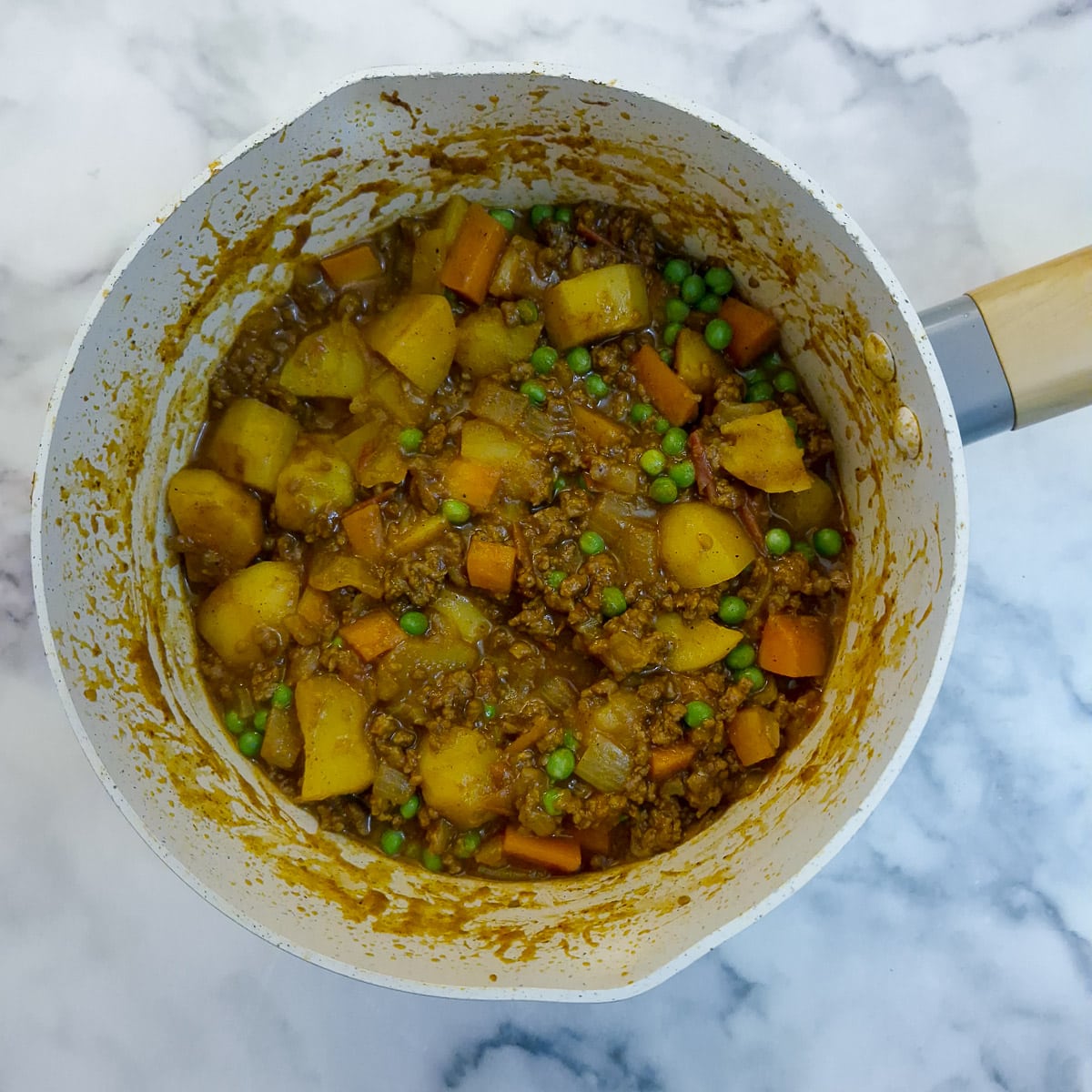 Step 6, a fully cooked pan of curry in a hurry, with peas stirred in.