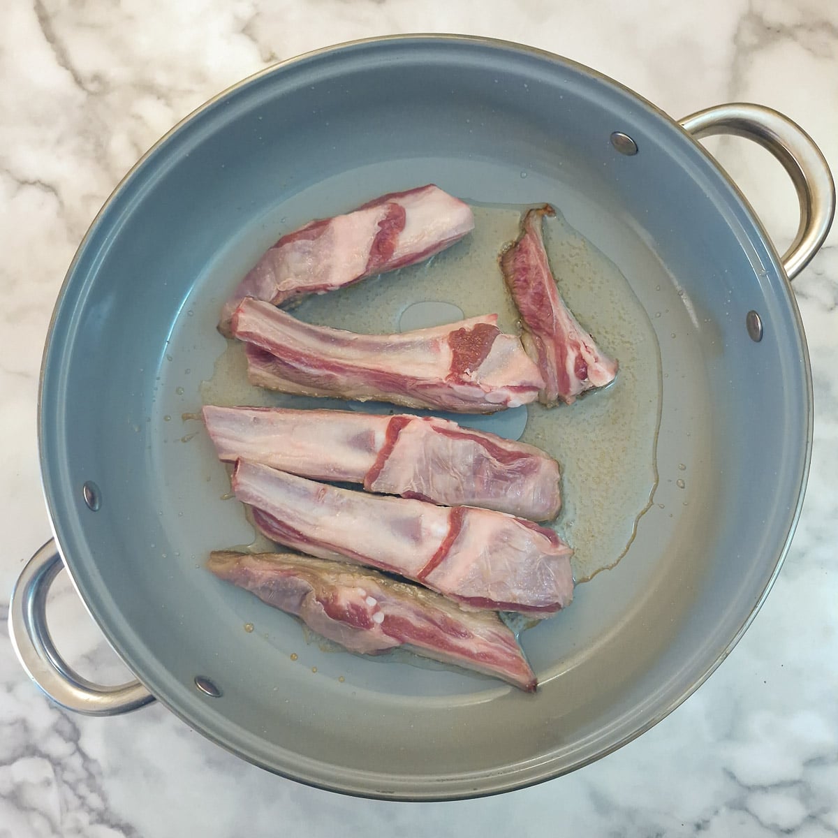Step 1 - lamb ribs in a large saute pan.