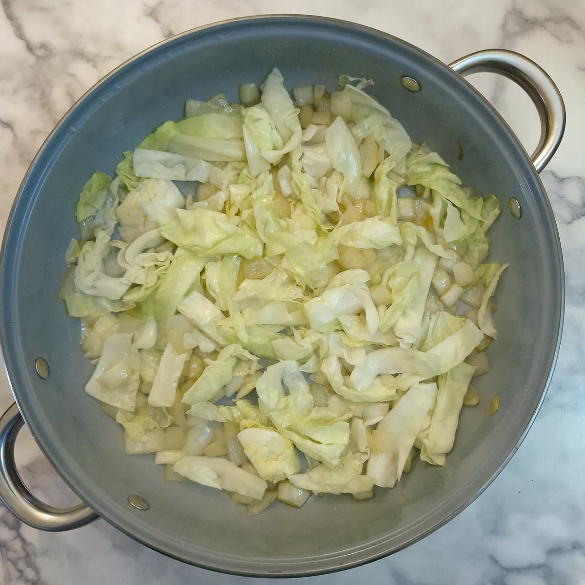 Step 4 - cabbage and grated potato stirred into the softened onions.