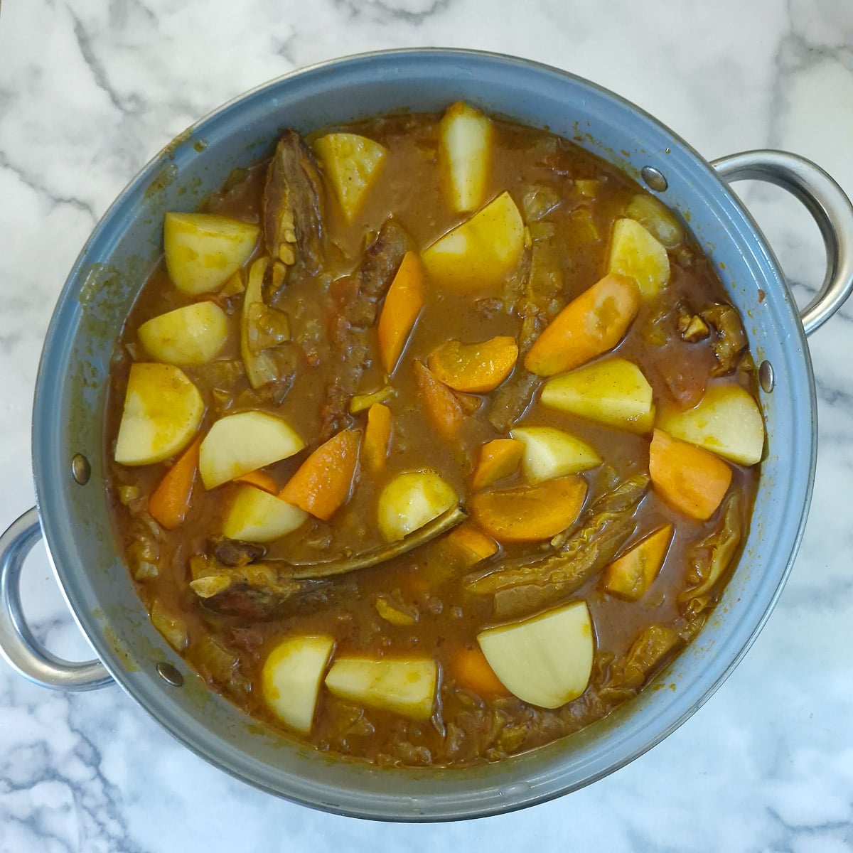 Step 9, potatoes and carrots added to the lamb rib curry.