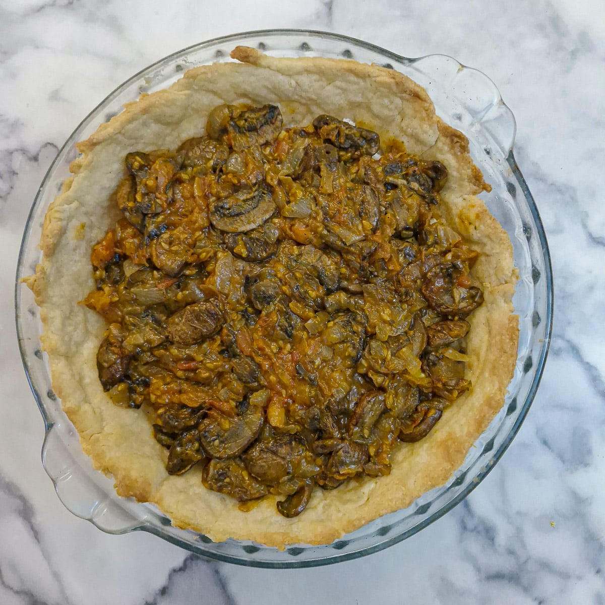 Step 10, tomato filling spread over the eggs in a pastry case.