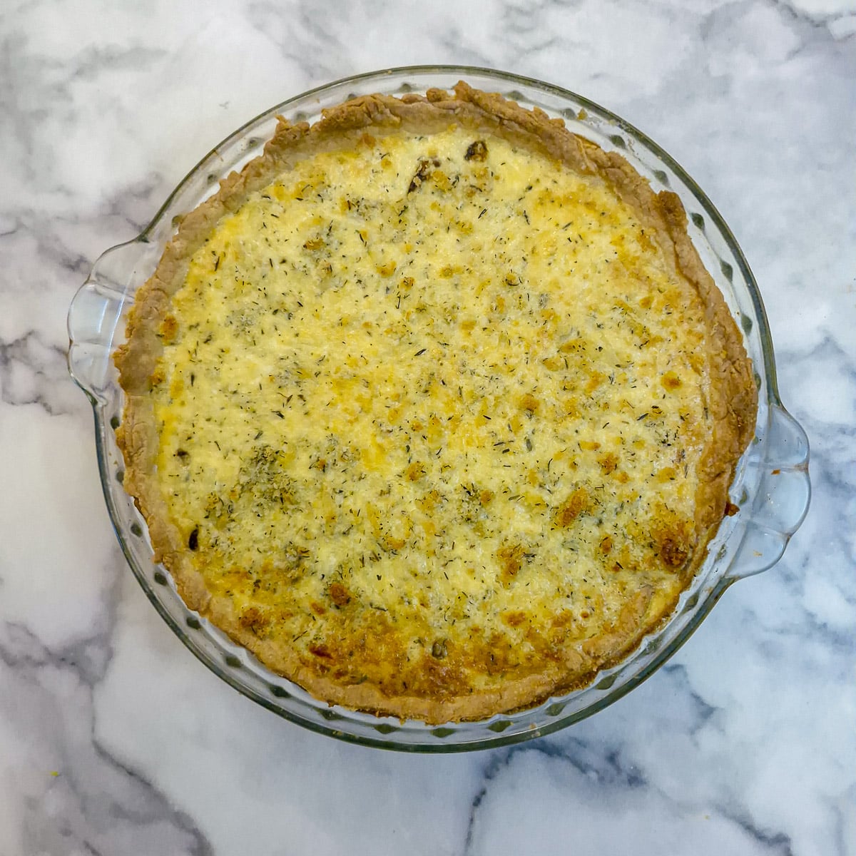 Step 14, overhead shot of a fully baked tomato and eqq quiche.