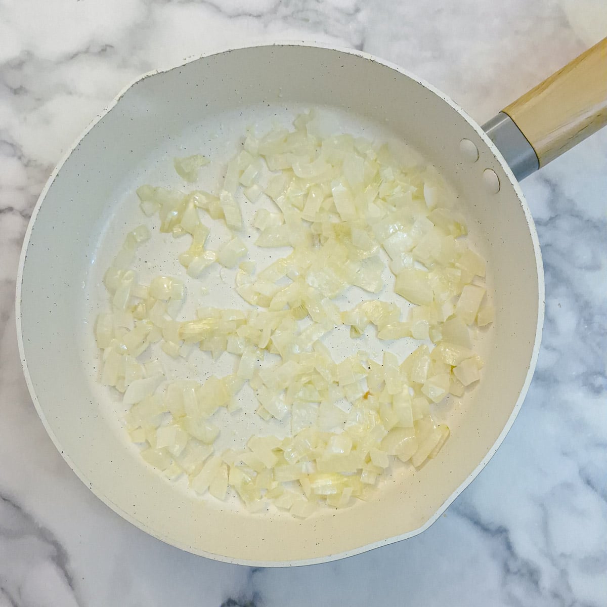 Step 3, onions softening in a frying pan.