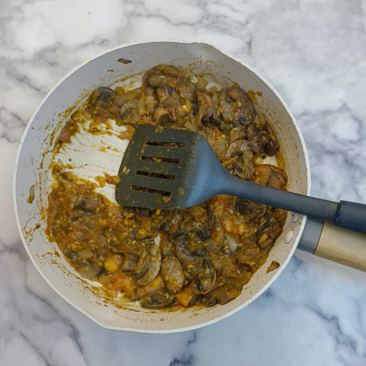 Step 5, tomatoes cooked with the mushrooms and onions until most of the moisture has evaporated.
