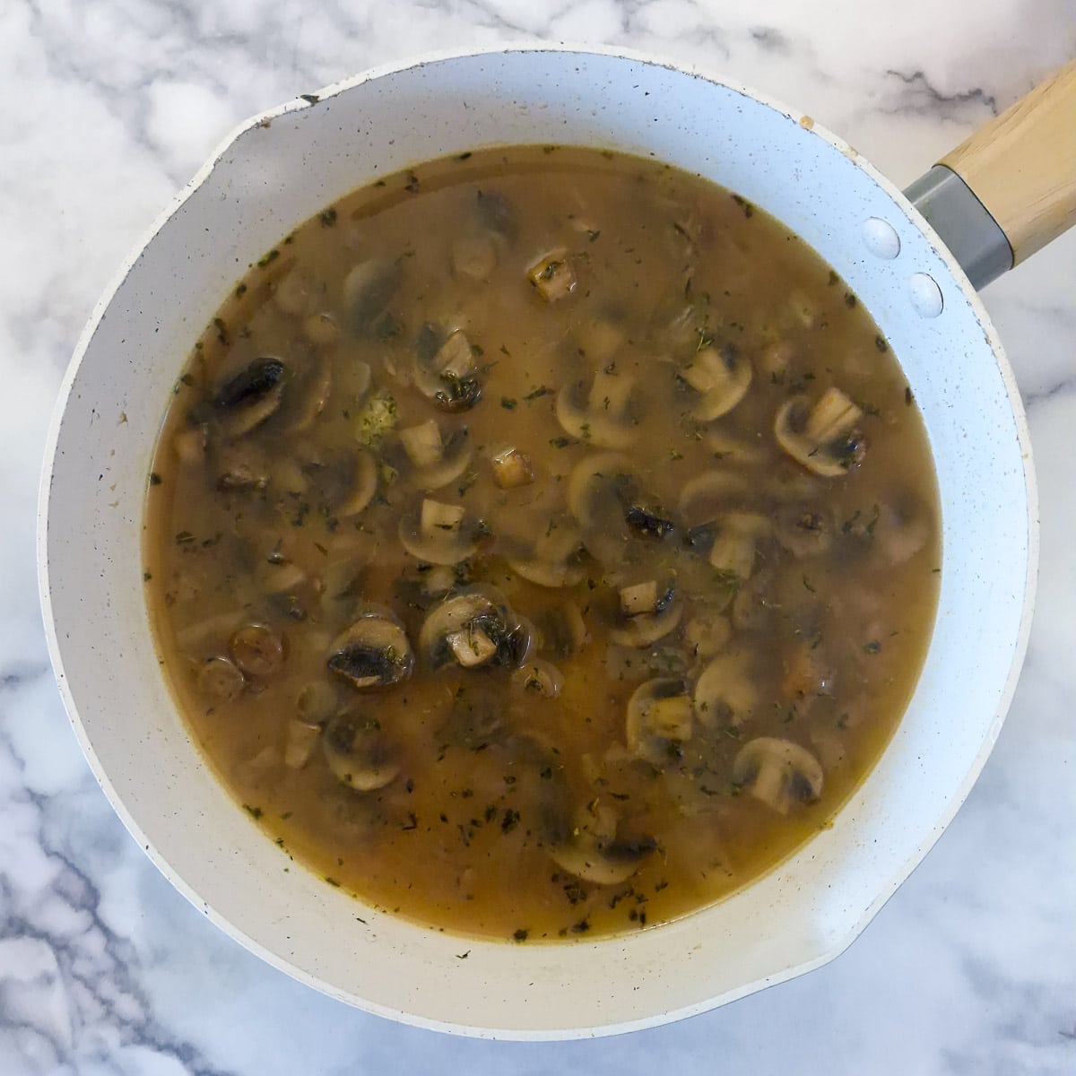 Step 11, stock added to the remaining mushrooms and onions to make the mushsroom and pate sauce.