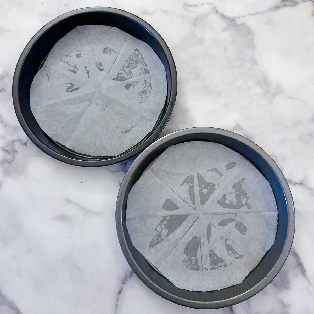 Step 2, baking parchment placed in the bottom of 2 cake tins.