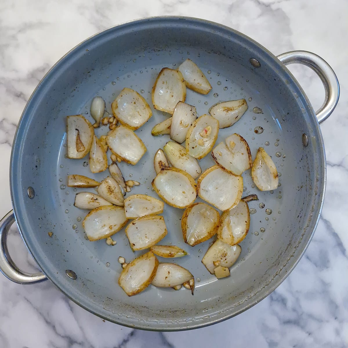 Onions browning in a pan.